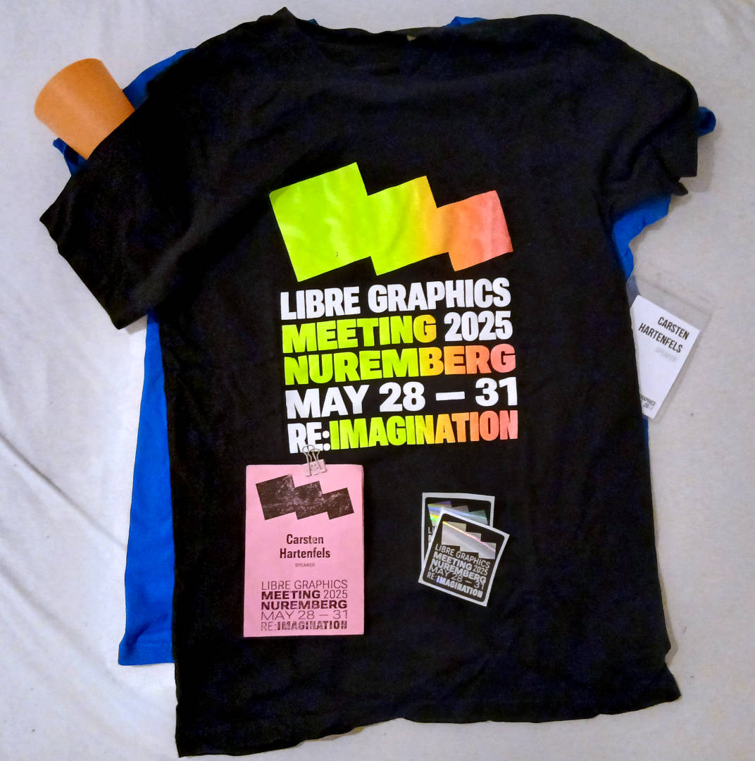 The black LGM 2025 shirt, a matching sticker and a pink paper name tag