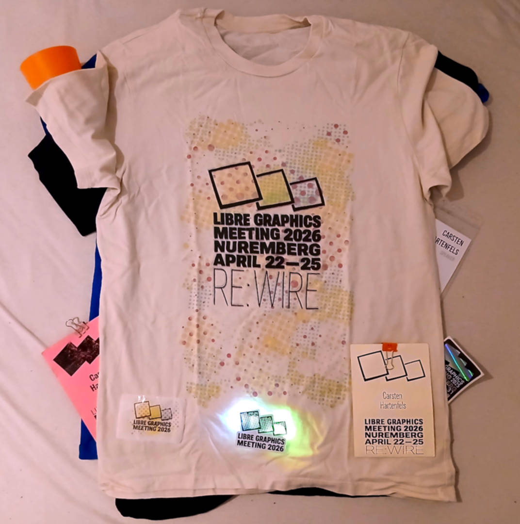 The white LGM 2026 shirt, a matching sticker, a white paper name tag and a logo glowing from LEDs inside its case